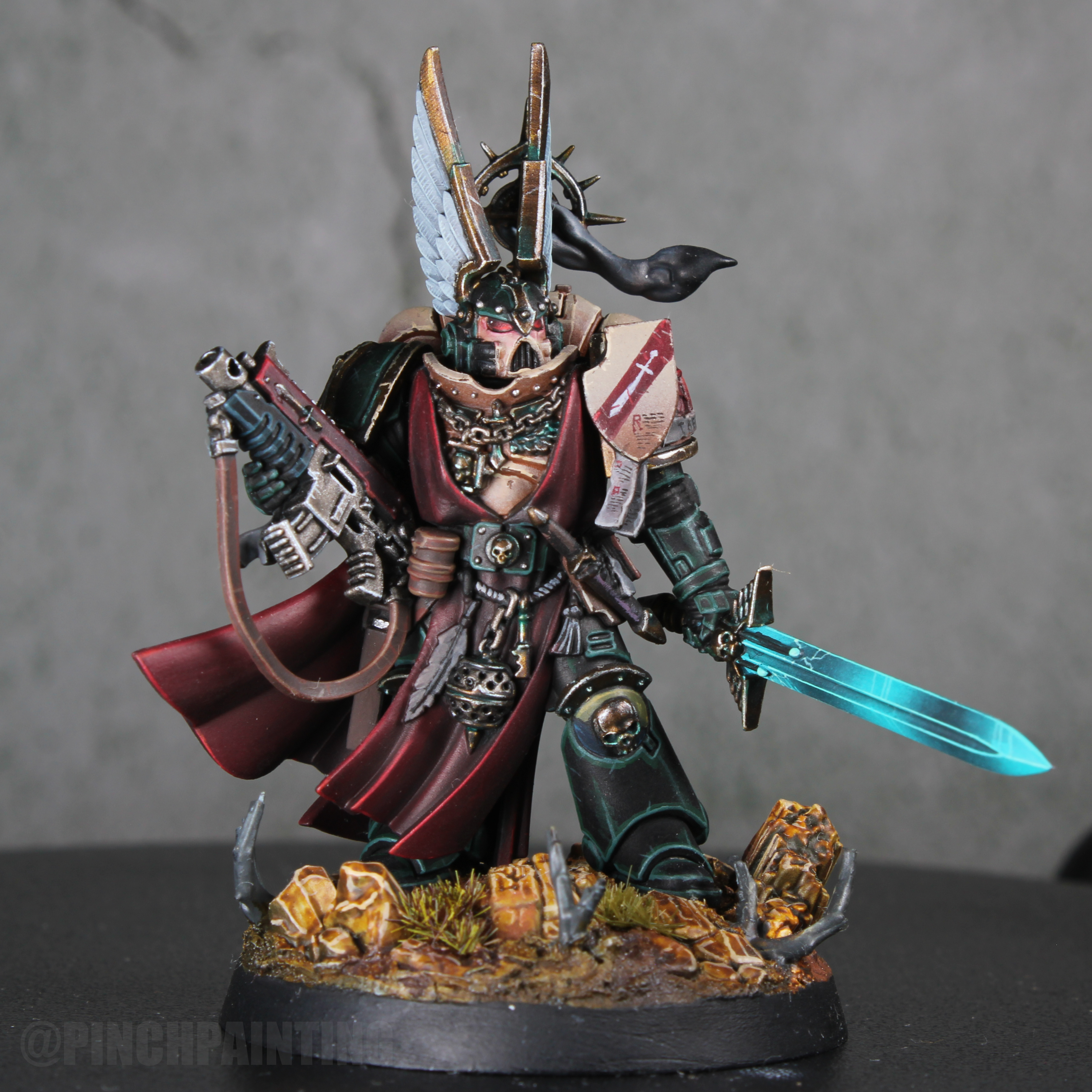 Lions Wrath Captain with a white helmet wing, crimson cloth, warm metal details, and a turquoise power sword