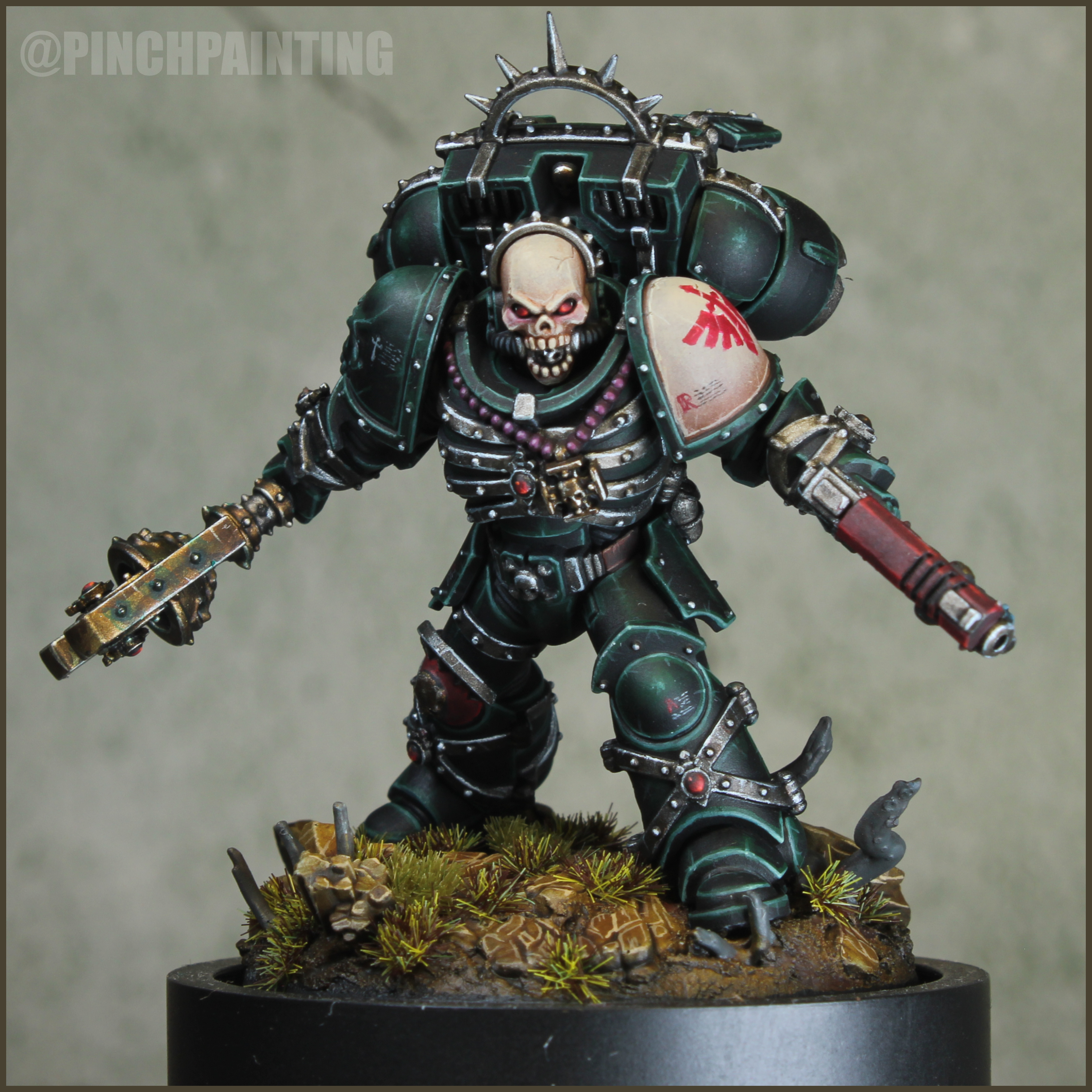 Jump Chaplain in dark green armor with a cream skull and shoulder, red pistol, aged gold crozius, and purple grip
