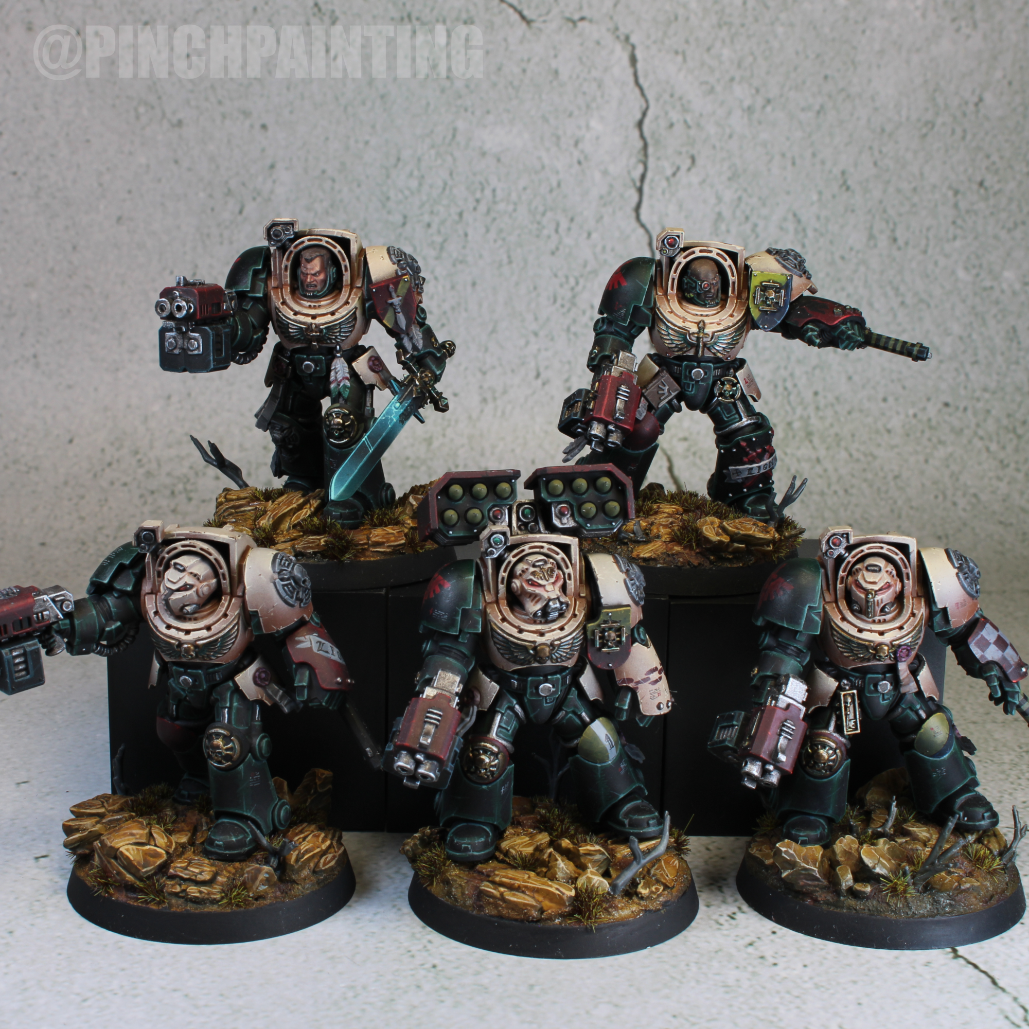 Five Lions Wrath Terminators with pale upper armor, dark green legs, red weapons, and warm rocky bases